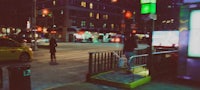 a person walking down a city street at night