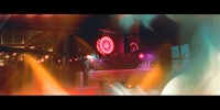a blurry image of a neon sign in front of a building