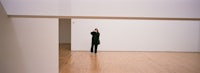 a person standing in an empty room with white walls