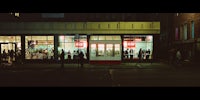 a storefront on a street at night