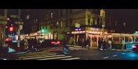 a city street at night with a lot of people