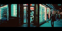a storefront with a neon sign