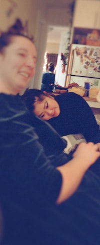 a woman and a man laying on a couch